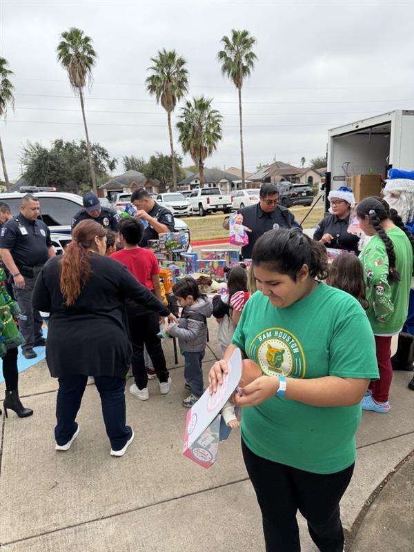 Students receiving toys from officers.