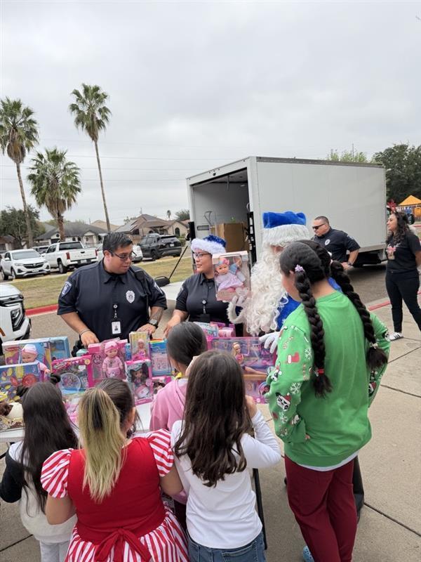 Students receiving toys from officers.