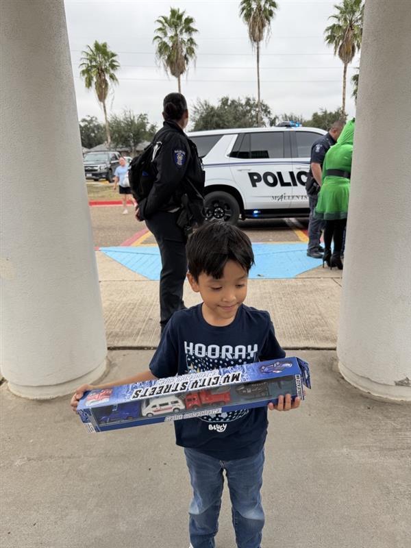 Student posing with toy.