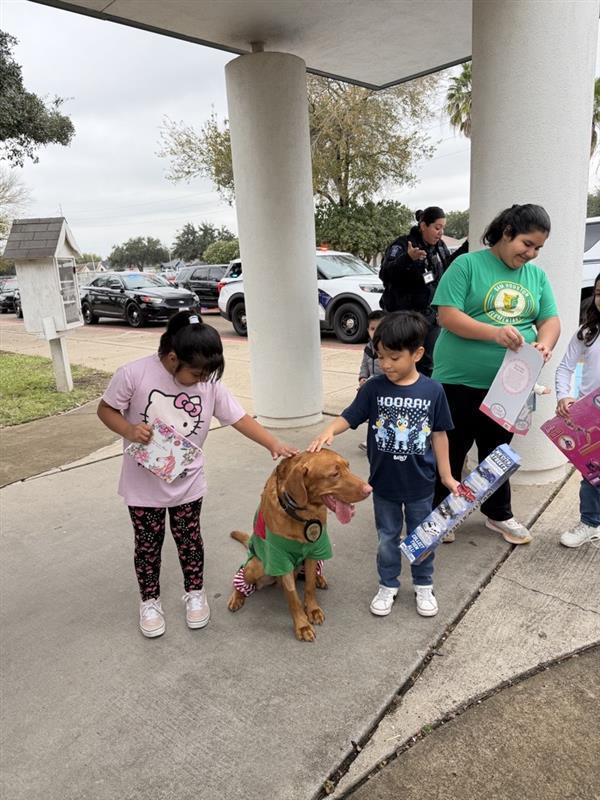Kids petting K9 officer.