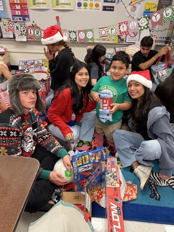 Students posing with gifts.