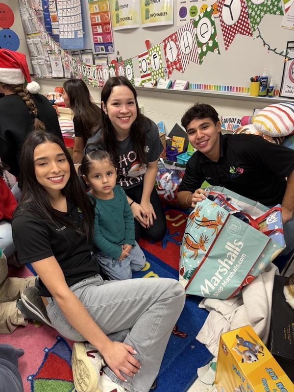 Students posing with gifts.