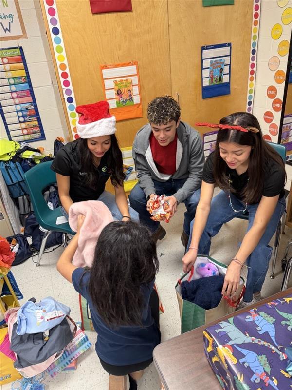 Students posing with gifts.