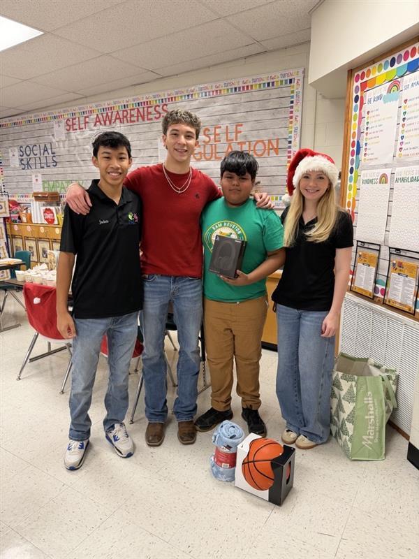 Students posing with gifts.