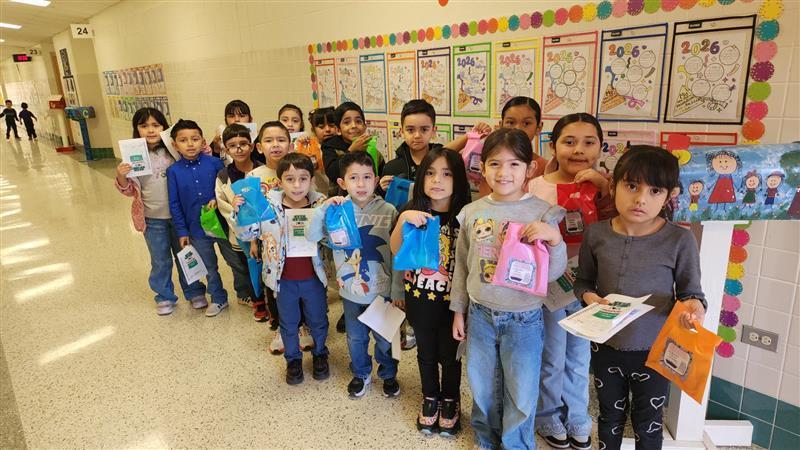 Kids posing with goodie bag.