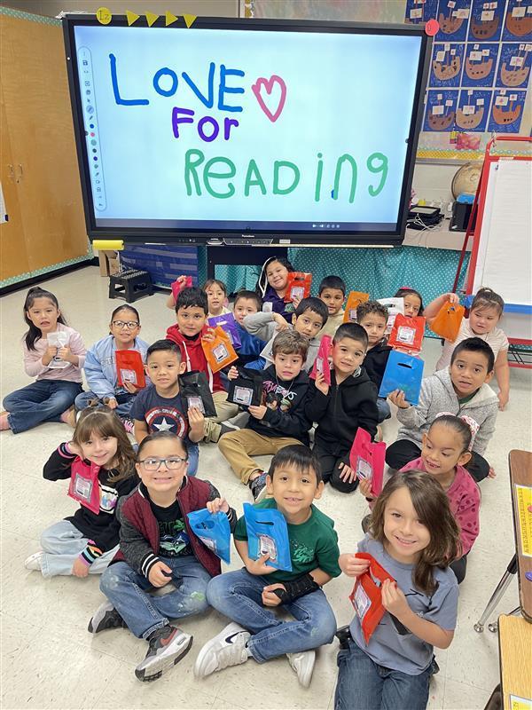 Kids posing with goodie bag.