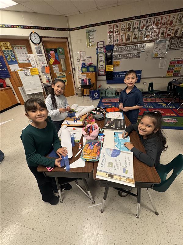 Kids posing as they work.