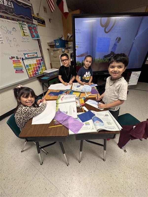 Kids posing as they work.
