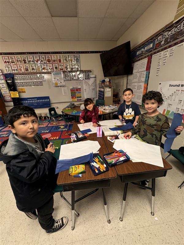 Kids posing as they work.