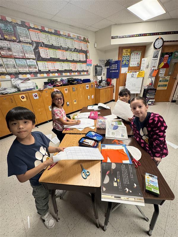 Kids posing as they work.