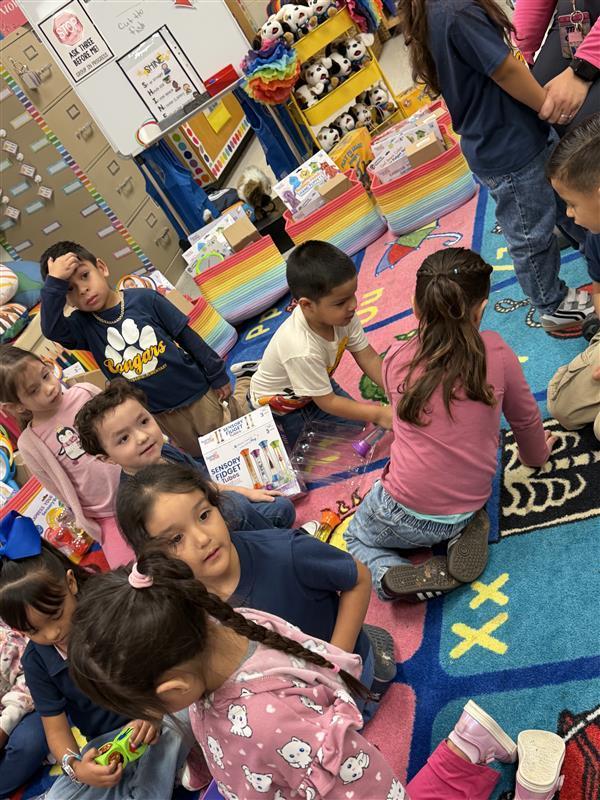 Kids opening packages with the peace pod tools.