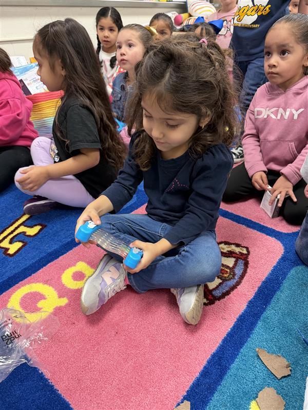 Kids opening packages with the peace pod tools.