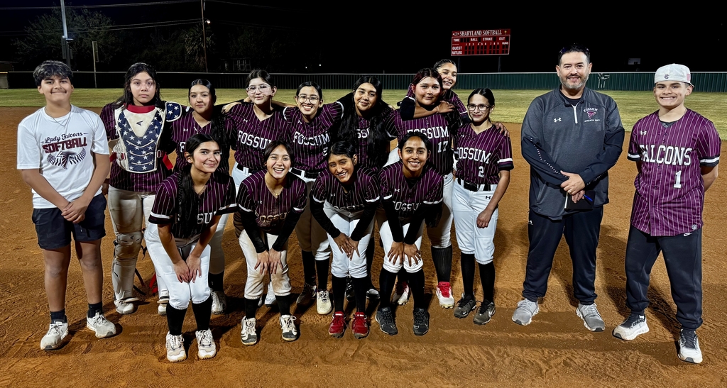 Group photo of the Fossum Middle School Lady Falcons softball team posing together on the field in their uniforms, smiling and celebrating after a game.