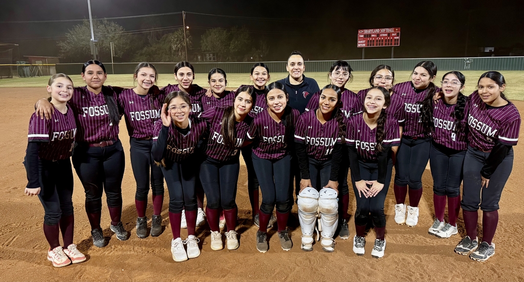 Group photo of the Fossum Middle School Lady Falcons softball team posing together on the field in their uniforms, smiling and celebrating after a game.