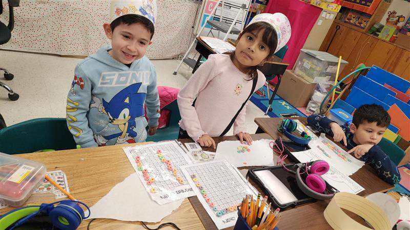 Kids posing while completing activity.