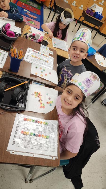 Kids posing while completing activity.