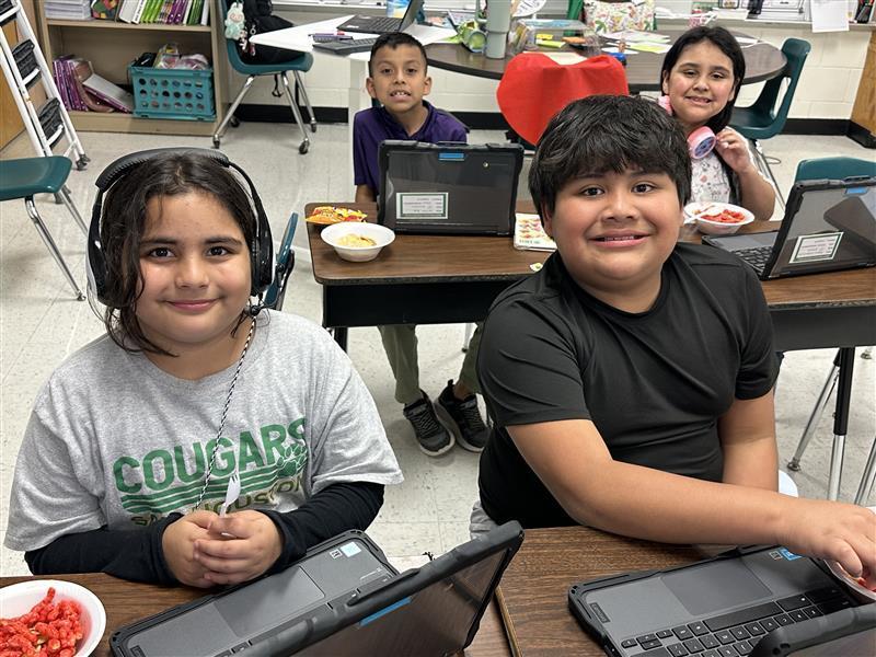 Students posing with treat.