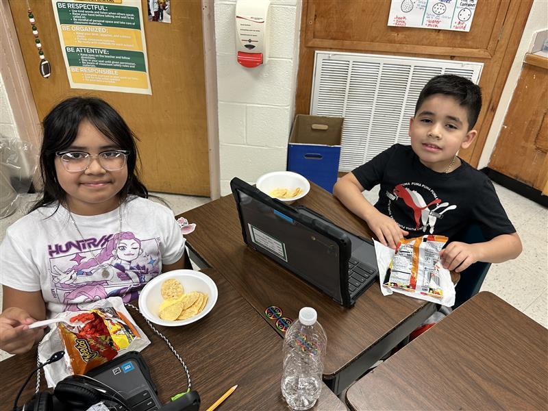 Students posing with treat.