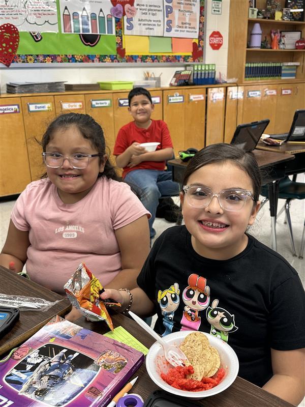 Students posing with treat.Students posing with treat.