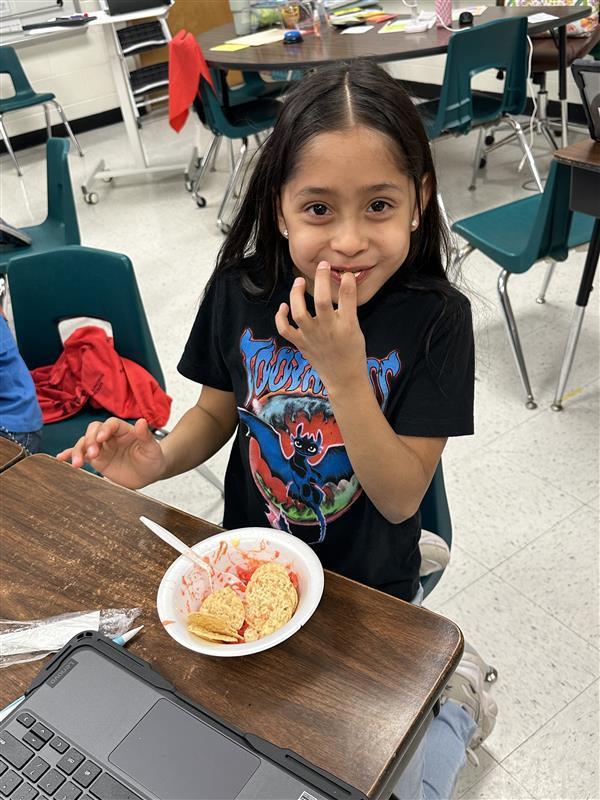 Students posing with treat.