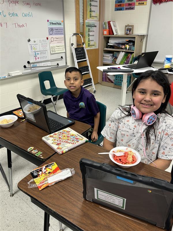 Students posing with treat.