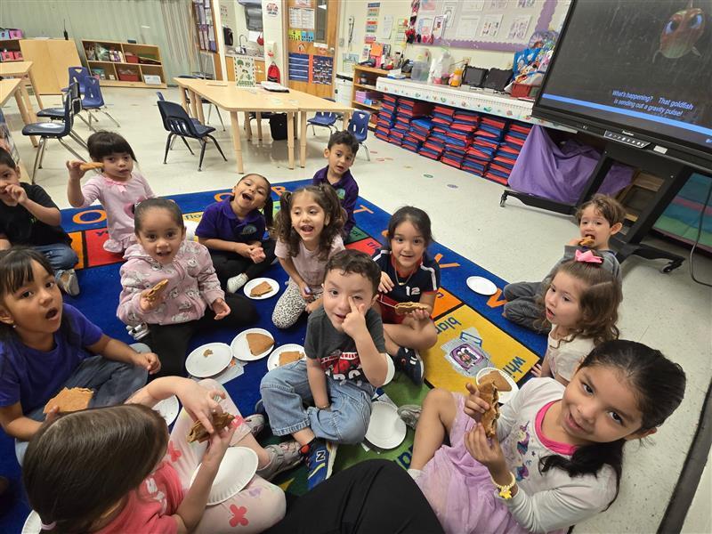 Kids eating empanadas.