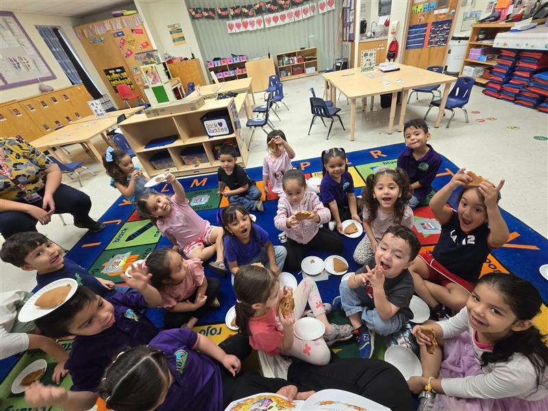 Kids eating empanadas.