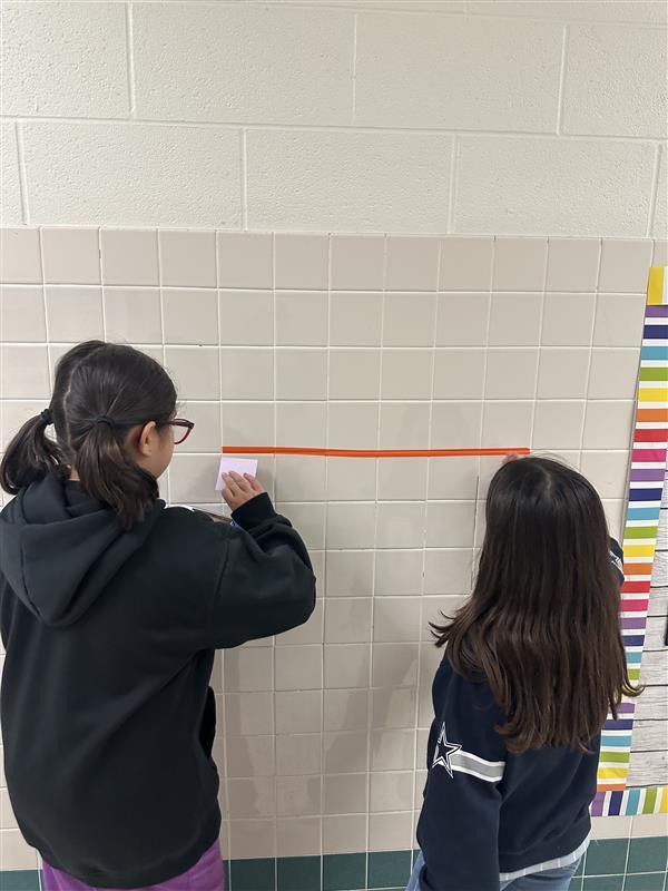 Kids working with fractions on a number line.