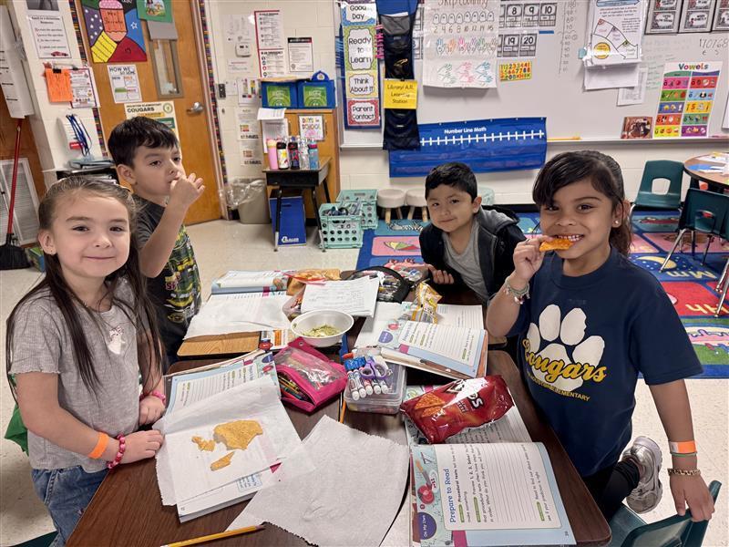 Kids posing enjoying salsa.