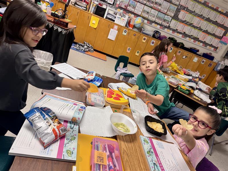 Kids posing enjoying salsa.