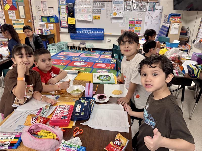 Kids posing enjoying salsa.