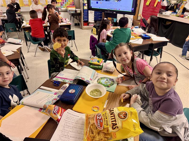 Kids posing enjoying salsa.