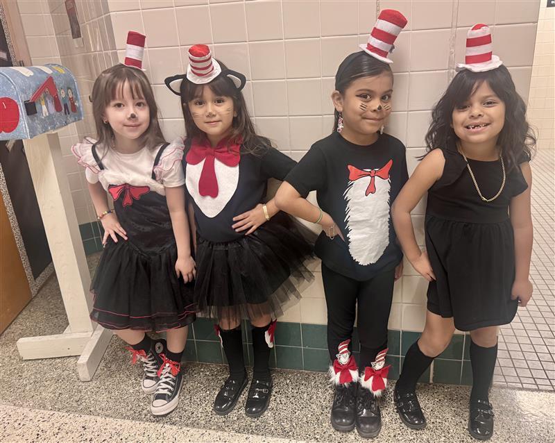 Kids posing dressed as Dr. Seuss characters.