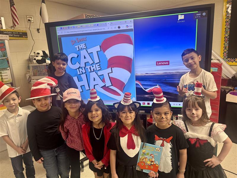 Kids posing dressed as Dr. Seuss characters.