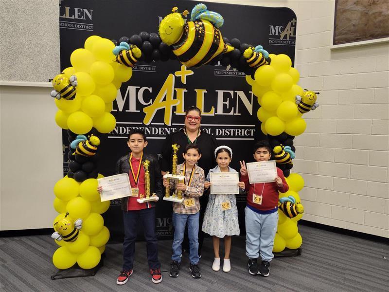 Kids posing with teacher.