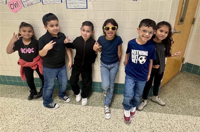 Kids posing with rock star attire.