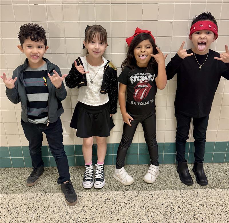 Kids posing with rock star attire.