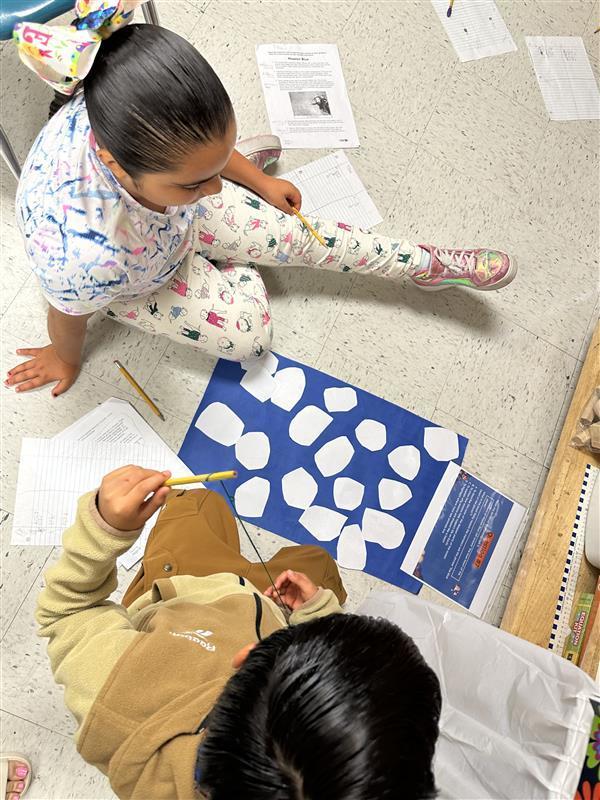 Kids engaged in a reading STAAR activity. 