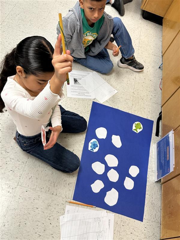 Kids engaged in a reading STAAR activity. 