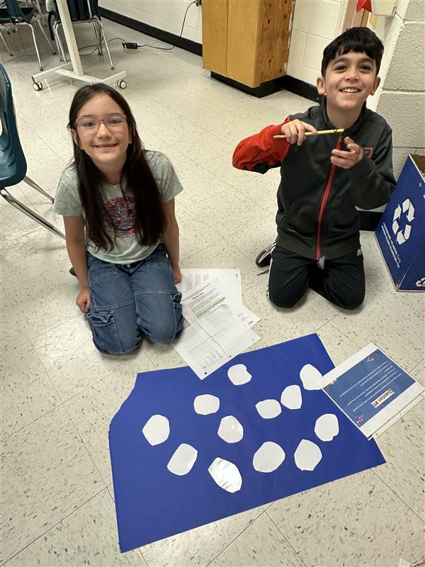 Kids engaged in a reading STAAR activity. 