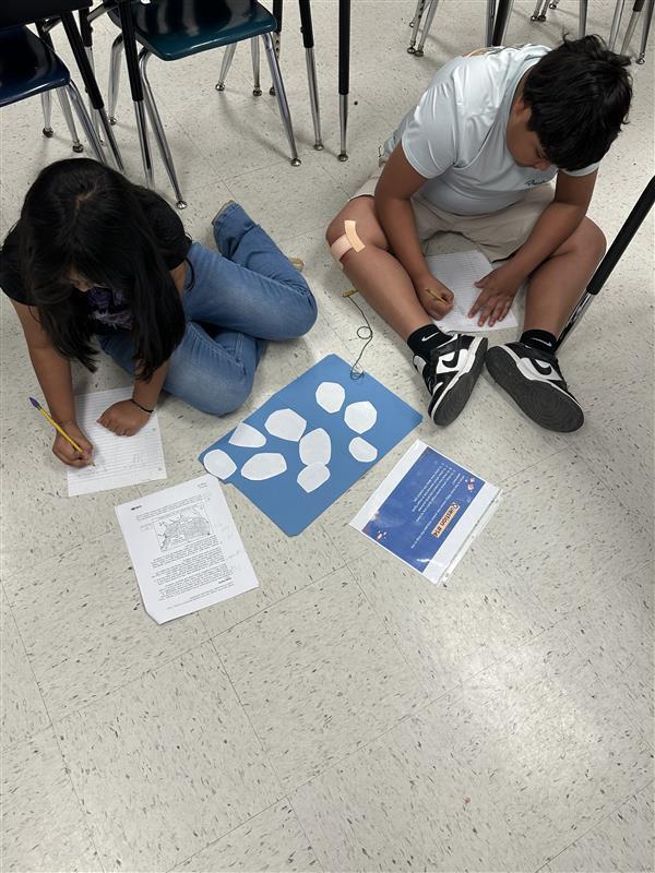 Kids engaged in a reading STAAR activity. 