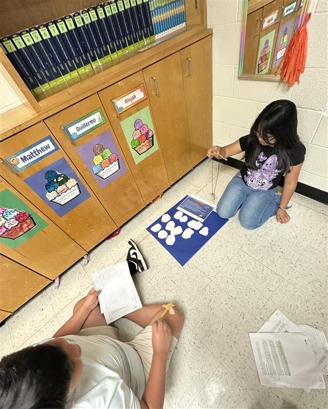 Kids engaged in a reading STAAR activity. 
