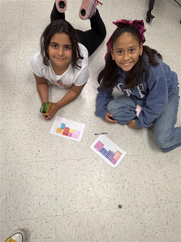 Kids posing as they complete game activity.