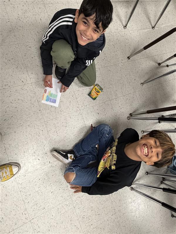 Kids posing as they complete game activity.