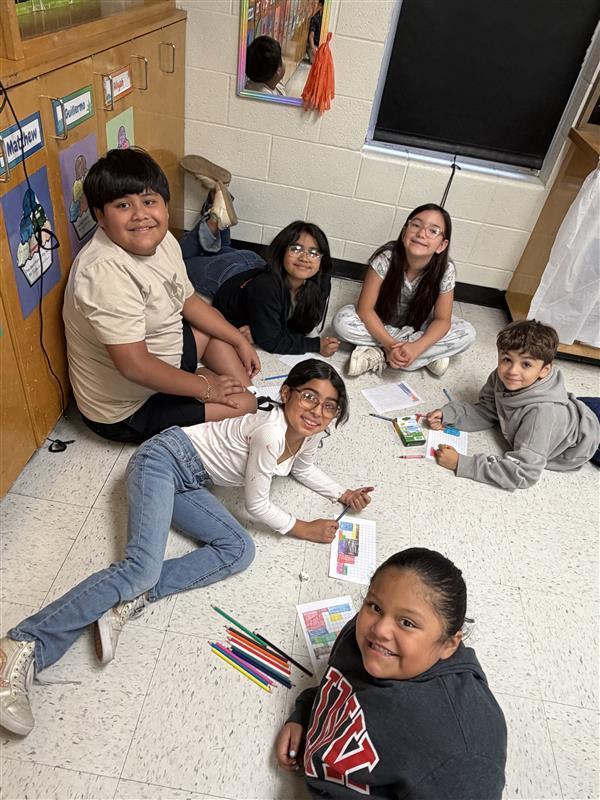 Kids posing as they complete game activity.