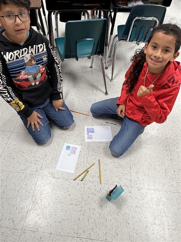 Kids posing as they complete game activity.