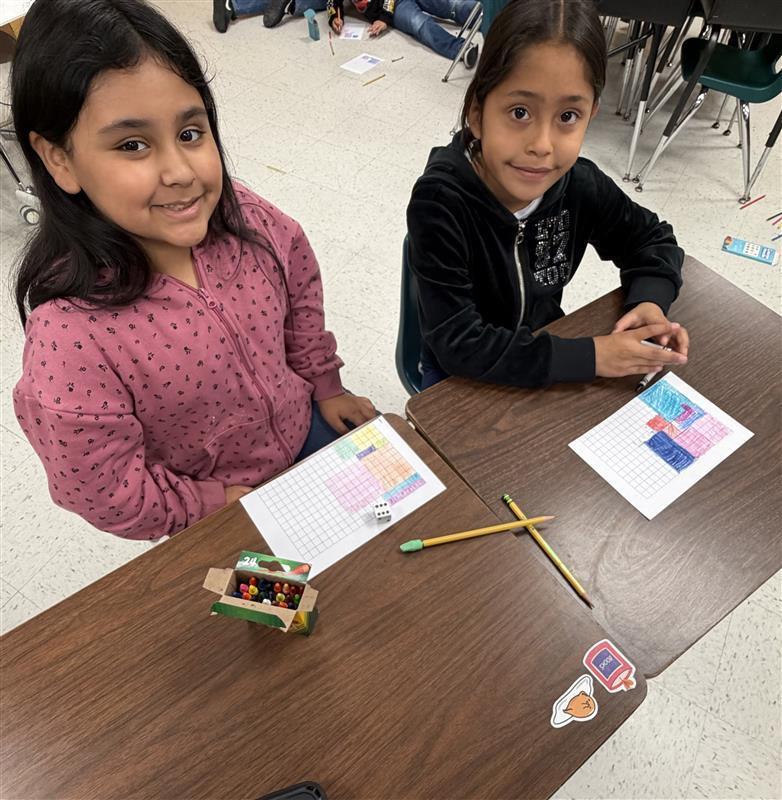 Kids posing as they complete game activity.