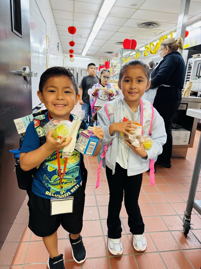 Students smiling at the breakfast line