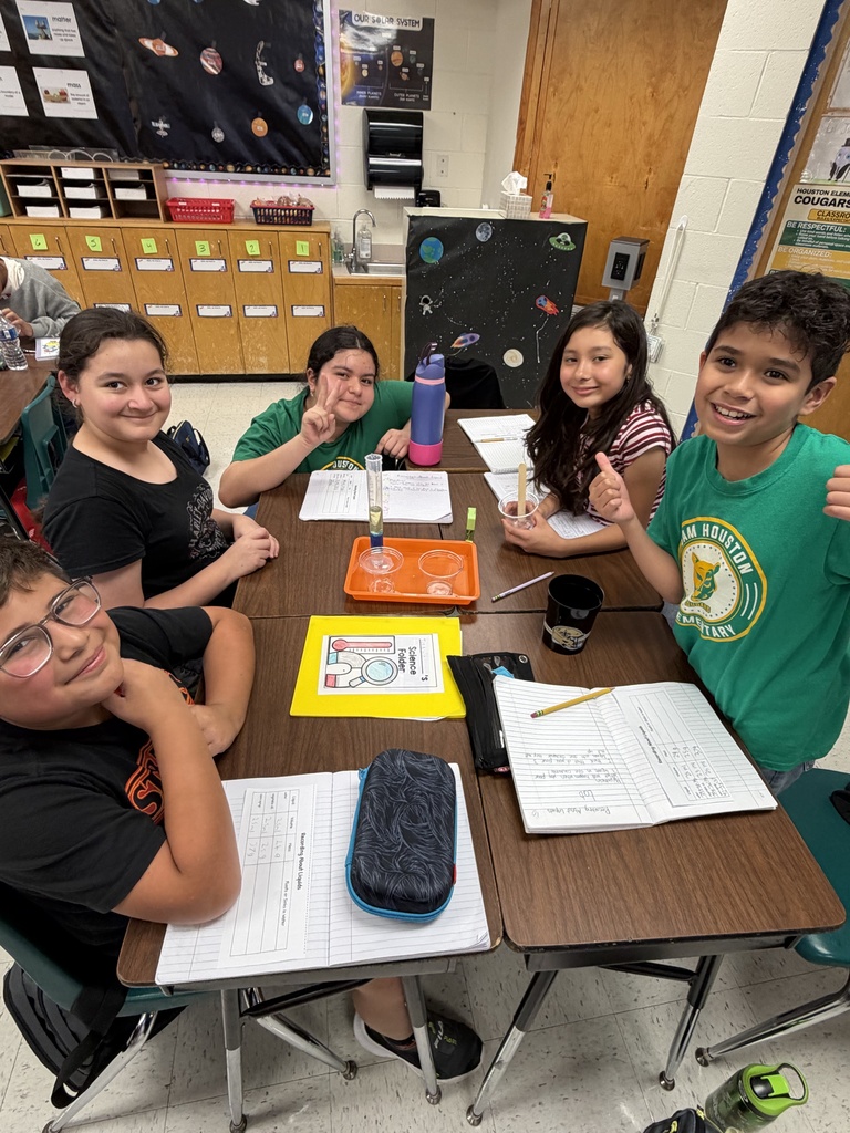 Kids posing during a science lesson.