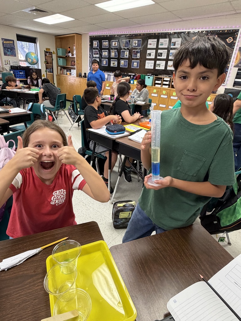 Kids posing during a science lesson.